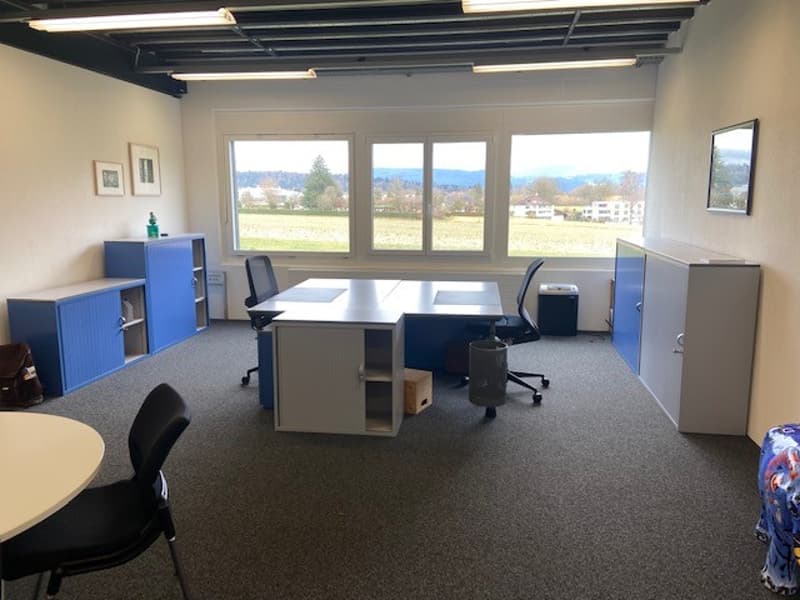 Empty room, desk, chairs, cabinets, windows