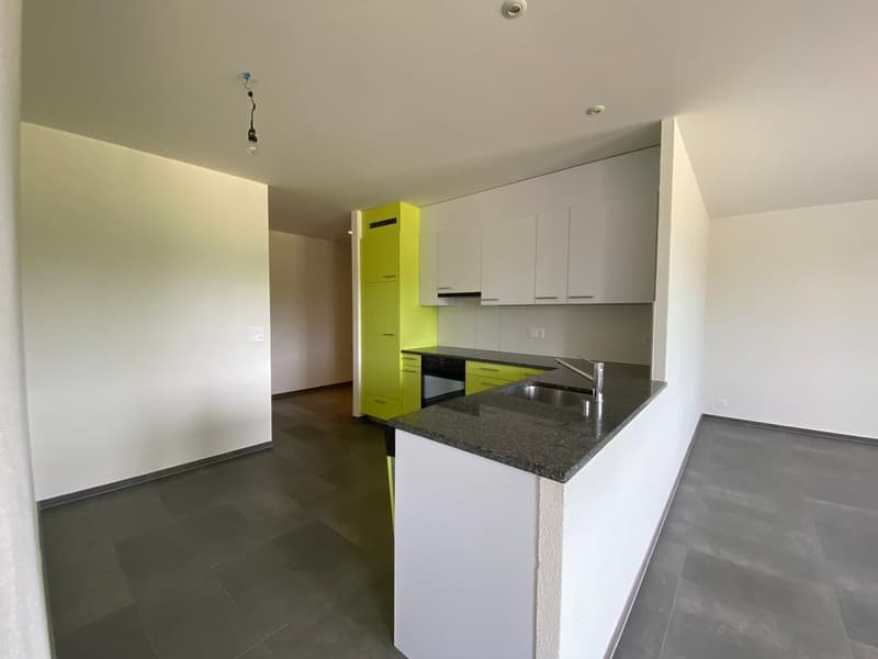 Modern kitchen with granite countertops, yellow cabinets, and white tiled flooring.