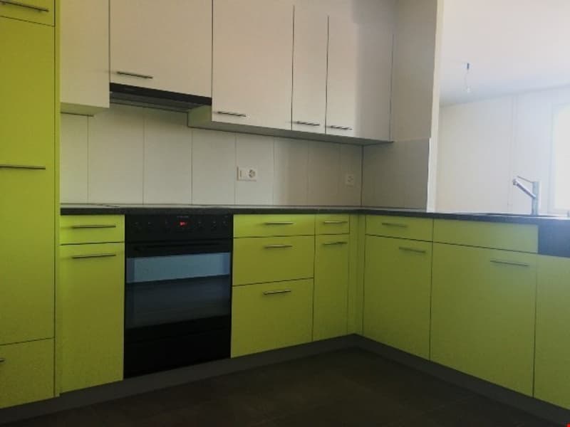 modern kitchen with white and lime green cabinets, gas stove, oven, sink with faucet, white countertops, white walls