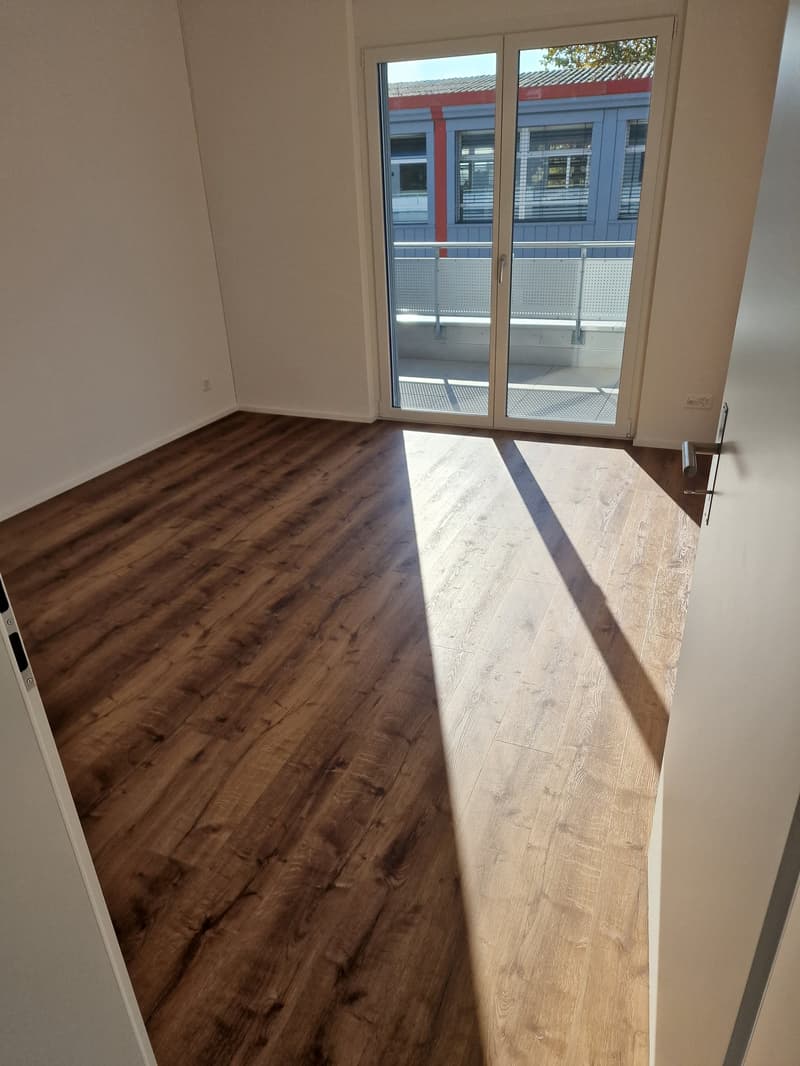 empty room, wooden floors, sliding glass door, balcony, white walls