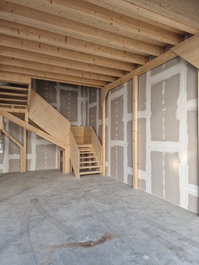 unfinished room, wooden stairs, unfinished plaster walls, empty