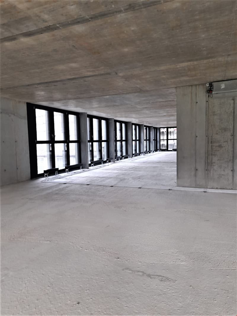 an empty corridor with windows and white floor