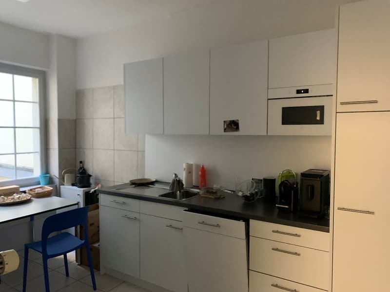 modern kitchen with white cabinets, countertops, sink, built-in microwave, open shelving