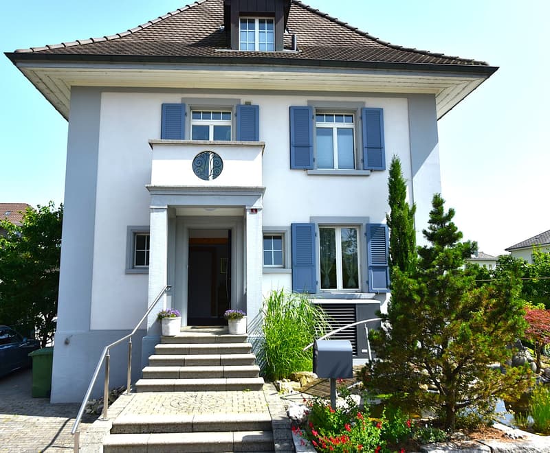 2 story house, white paint, blue shutters, concrete path, mailbox, flower bed, 2 flower pots
