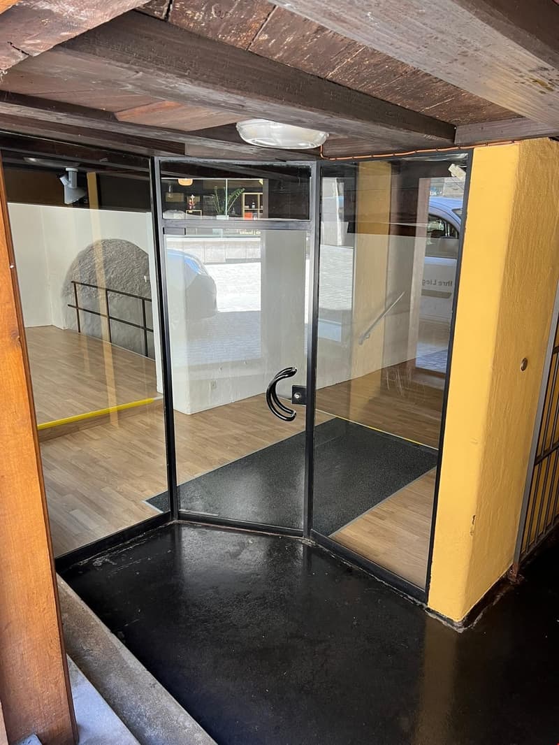 double glass door, raised ground floor, wooden flooring, metal railings, ceiling lamp