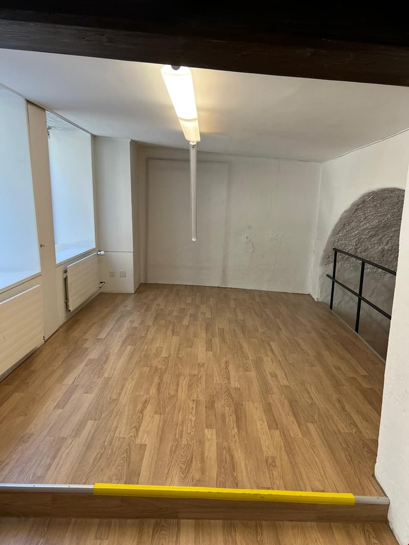 Empty room, wooden floors, white walls, large window, ceiling light, balcony, window sill with radiators
