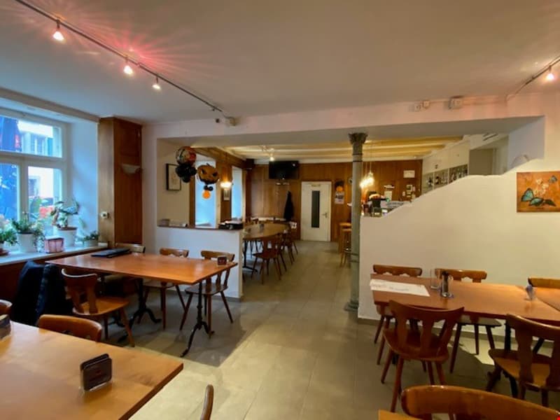 long tables, wooden chairs, white walls, window