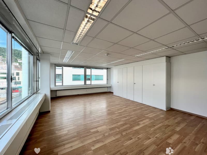 Empty room, large windows, white walls, white ceiling, wooden floor, built-in white cabinets