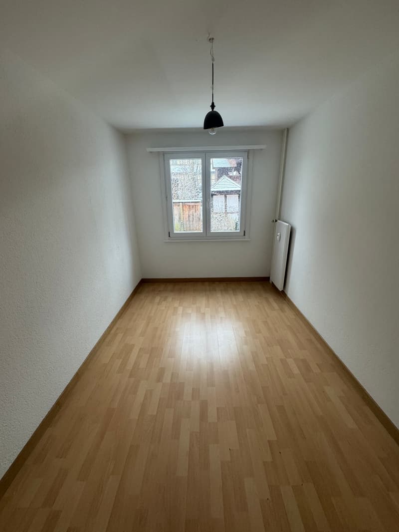 empty room, wooden floor, white walls, window, radiator