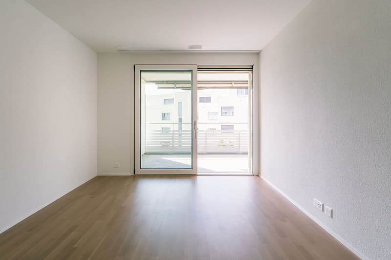 empty room, wooden floor, white walls, sliding glass doors, balcony