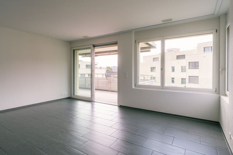 empty room, white walls, tiled floor, sliding glass doors to balcony, large window