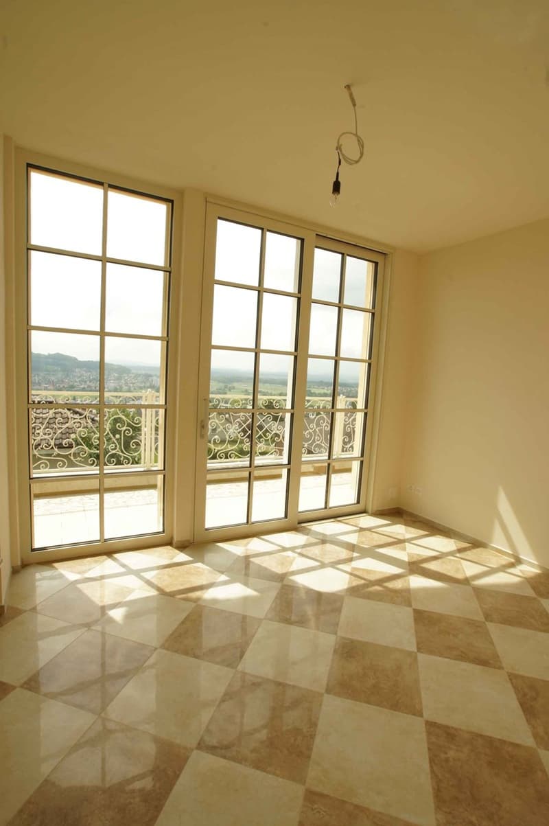 checkered tile floor, French glass doors with ornate railings leading to balcony, unobstructed view