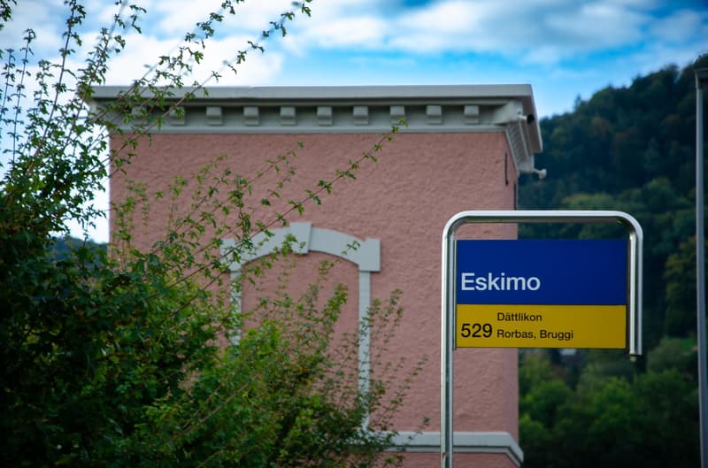 modern pink building with sign board