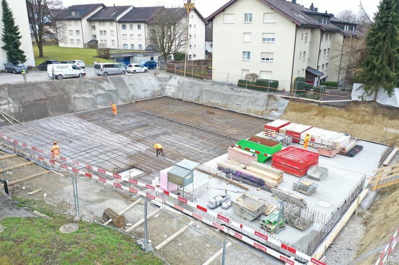 excavation site, building foundation, rebars, construction workers, various building materials