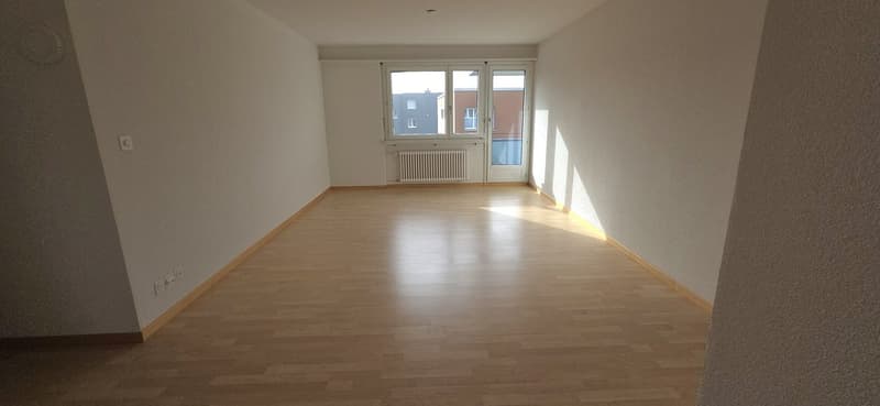 Empty room, white walls, wooden floor, windows, power outlets