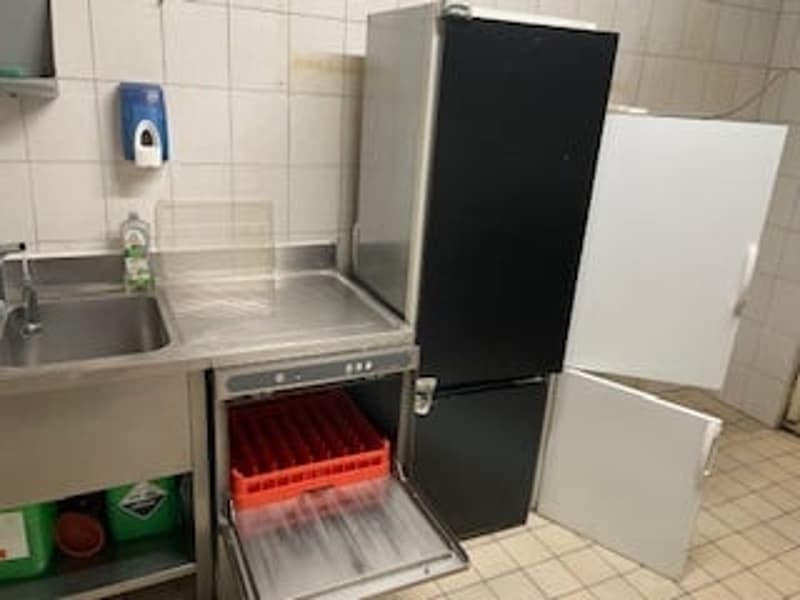 Commercial kitchen with sink, refrigerator, and dishwasher