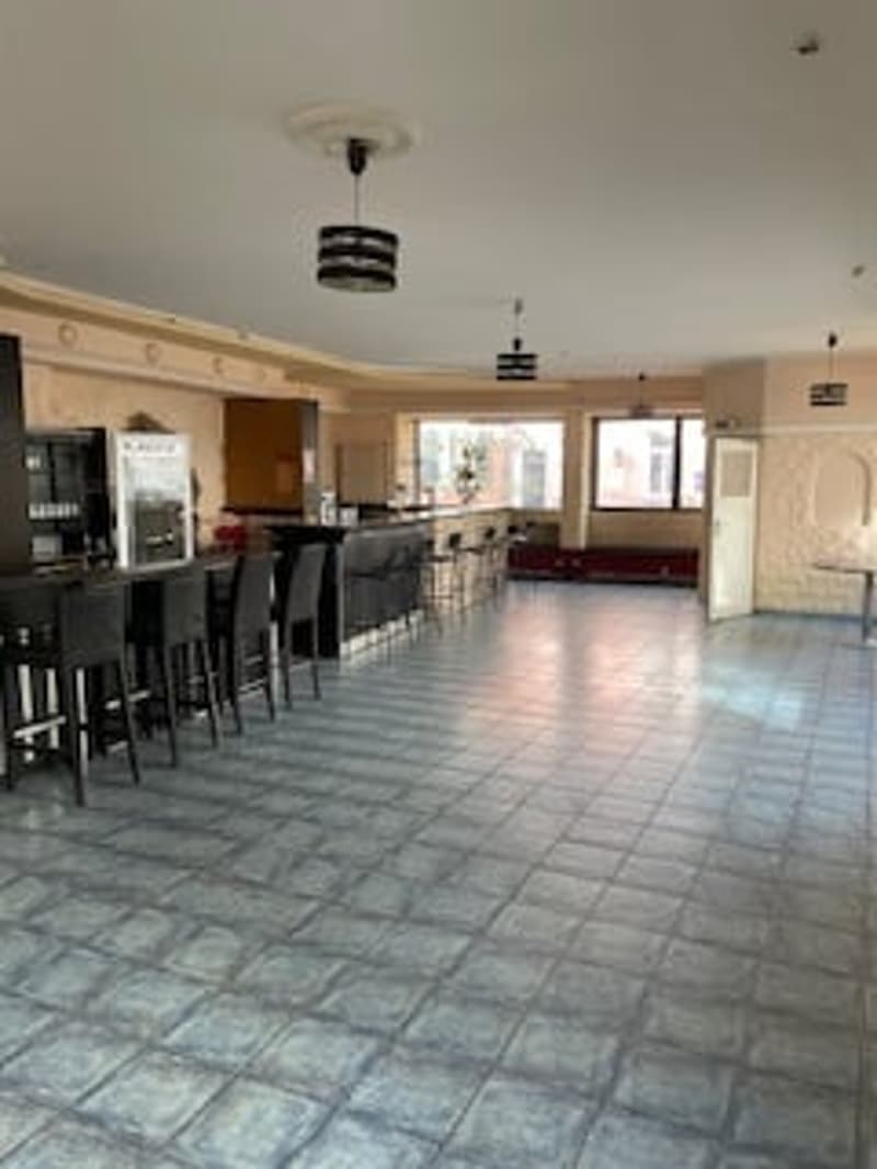 empty room, tiled floor, black chairs, bar counter, lamps
