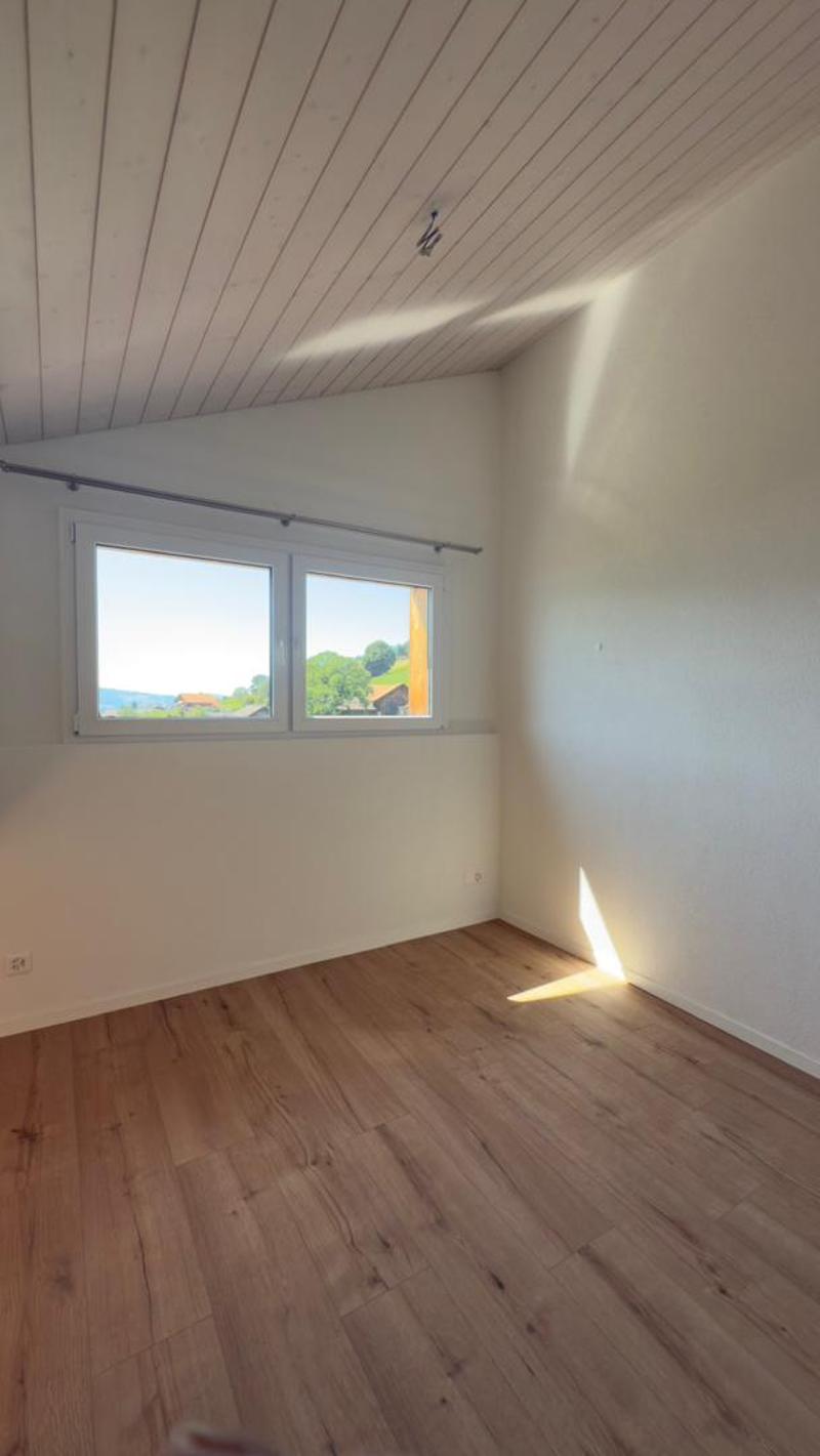 empty room, wooden floor, white walls, large window, view of the outside