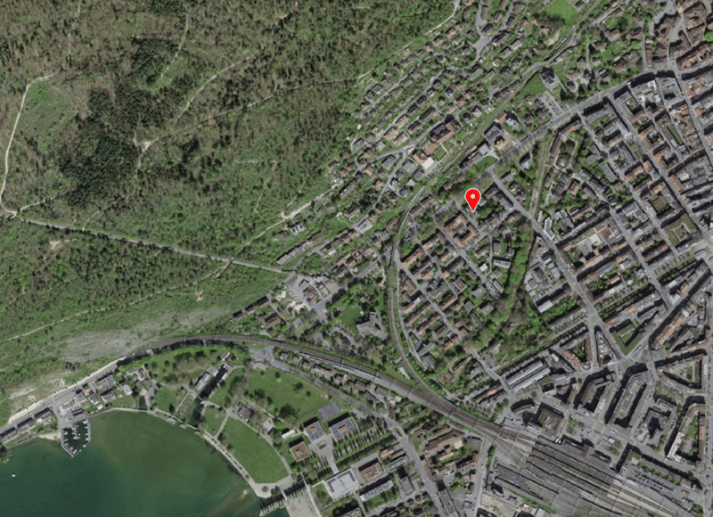 Aerial view of a town with many buildings, roads, and a body of water.
