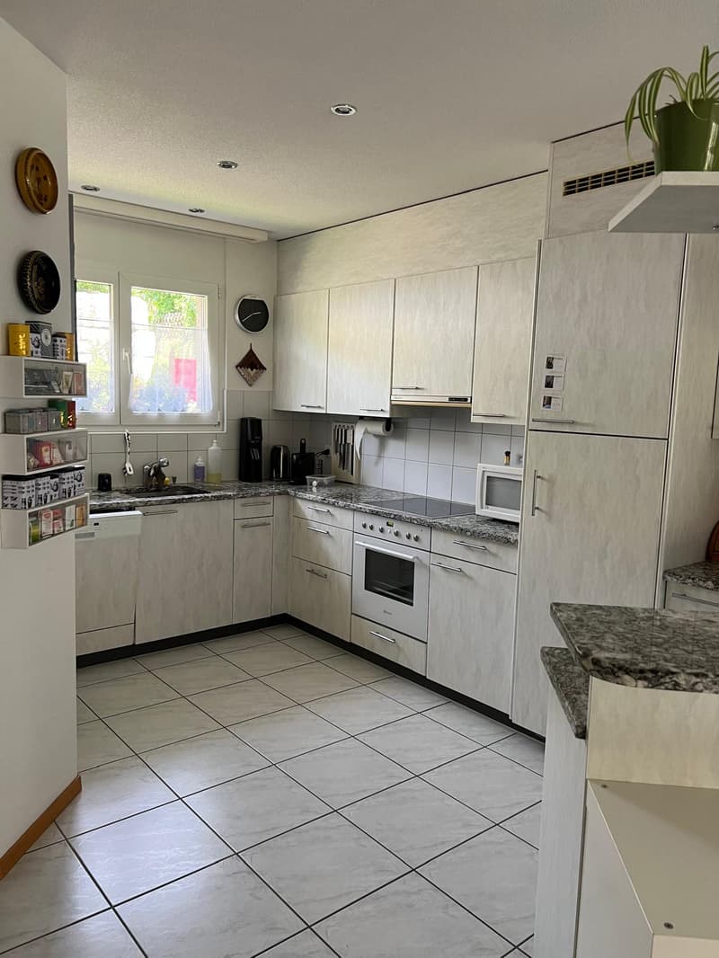 modern kitchen with white cabinets, granite countertops, white tiled floor, white appliances, sink with faucet, window with curtains