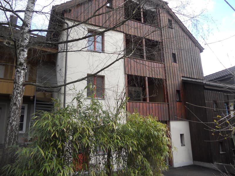 multistory building, wooden exterior, balcony, window, shrubs