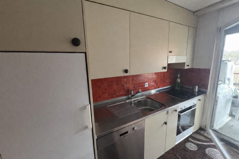 kitchen with stainless steel countertop, stainless steel sink, electric cooker, dishwasher, fridge, gas stove, cabinets, tiled wall, glass door to balcony