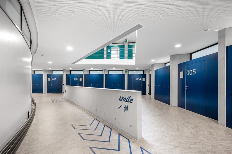 empty room, blue doors, white walls, concrete floor, blue floor pattern