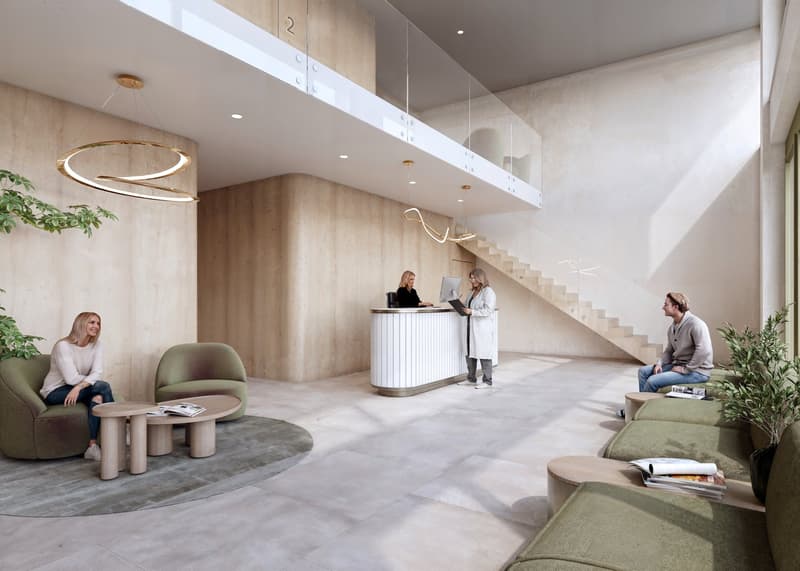 The lobby area features a reception desk, green lounge chairs, modern wall design, and hanging lights, with a staircase leading to an upper level.