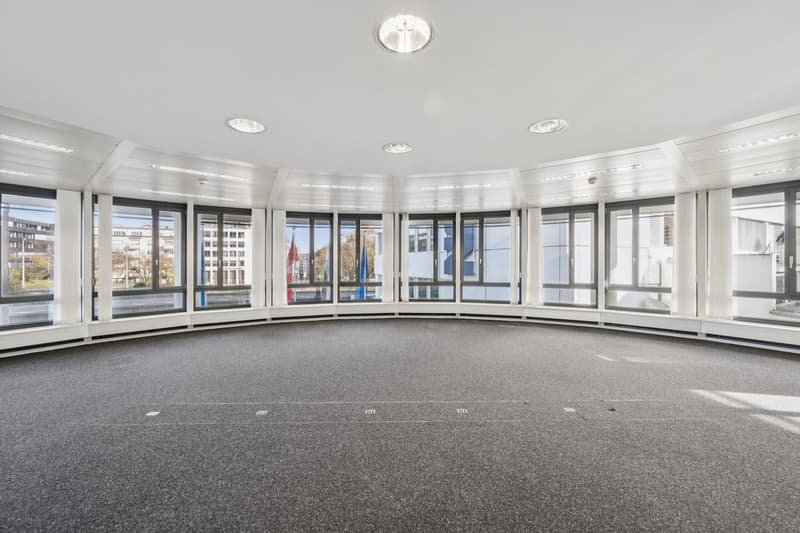 open floor plan, large windows, view of the outside, carpeted floor