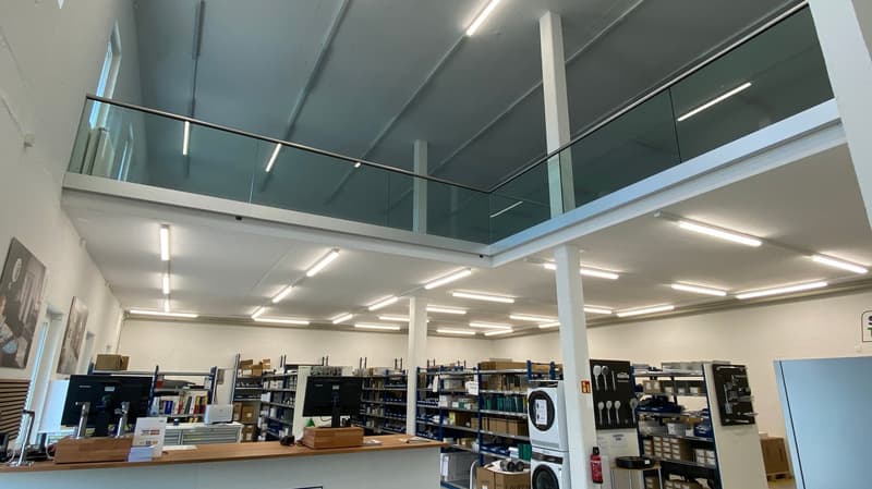 office space with glass balcony, shelves, computers, storage boxes, appliances