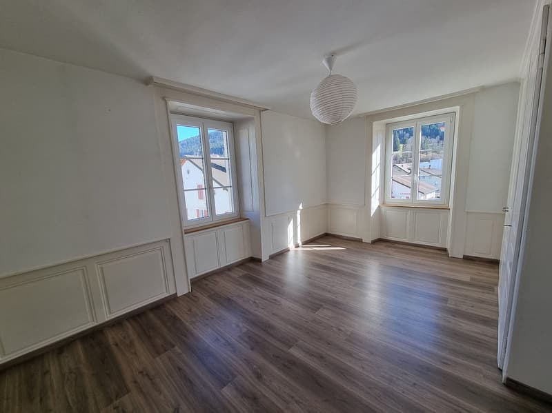 modern room, wooden floors, white walls, two large windows, lamp