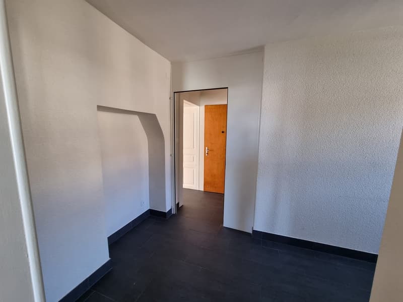 empty room, wooden door, tiled floor, white walls