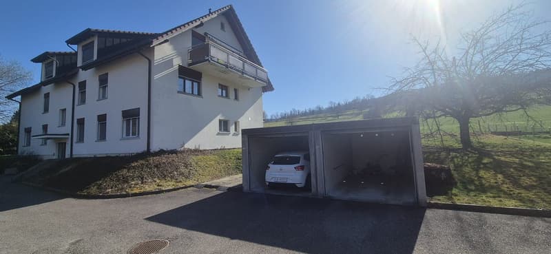 2-story house, garage with two cars parked