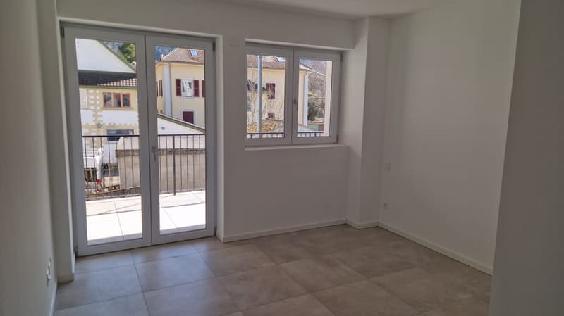 tiled floor, sliding doors, windows, balcony, white walls
