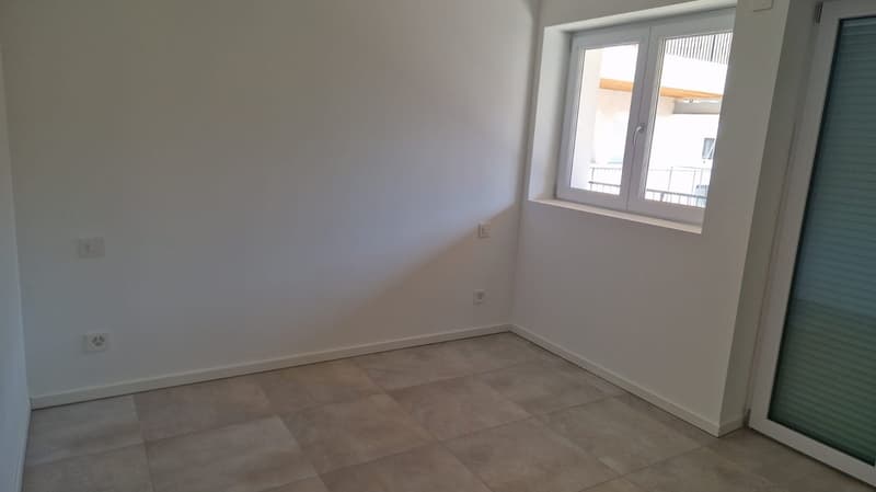 White walls, floor, balcony access, outlets