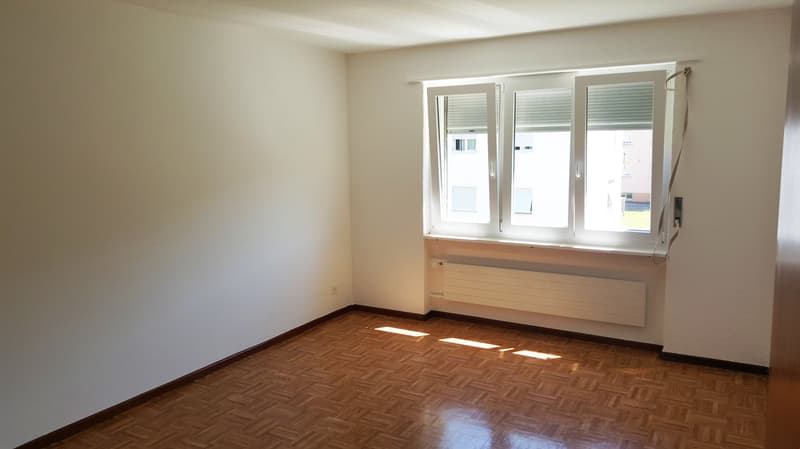 empty room, white walls, wooden floor, large window, radiator