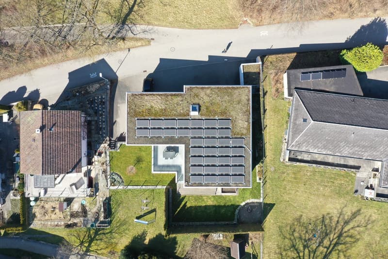 House with solar panels on the roof and on the ground floor