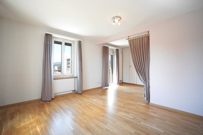 empty room, hardwood floor, large windows, ceiling lamp, white walls, brown curtains