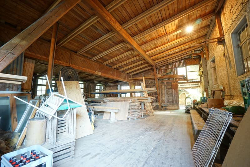 wooden structure, various wooden planks, storage boxes, metal cages, metal shelves