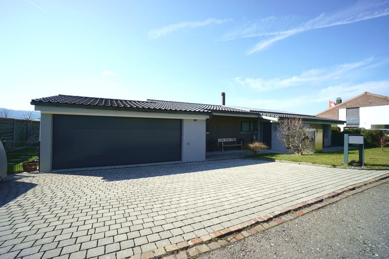 modern house, brick driveway, garage, solar panels