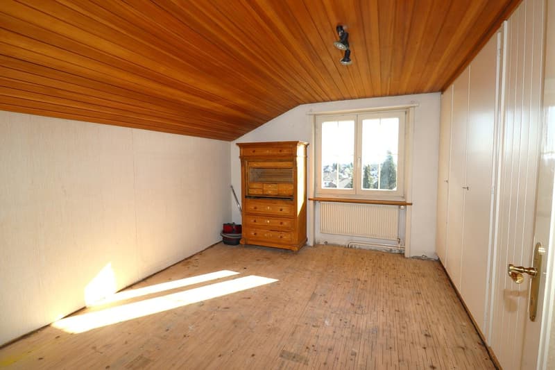 empty room, wooden floors, wooden ceiling, wooden cabinet, window with radiator