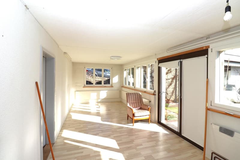 empty room, hardwood floor, ceiling lamp, sliding door, windows, large hallway, chair