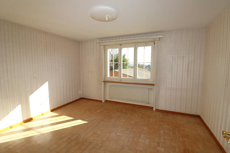 empty room, wooden flooring, white walls, window, radiator, light on ceiling