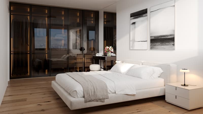 Bedroom with wooden floor, white walls, white bed, white nightstand, white lamp, glass sliding doors, flower vase, artwork, and black cabinet.