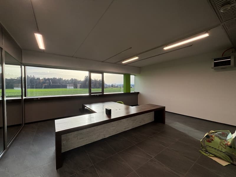 large windows, wooden desk, tiled floor, air conditioner