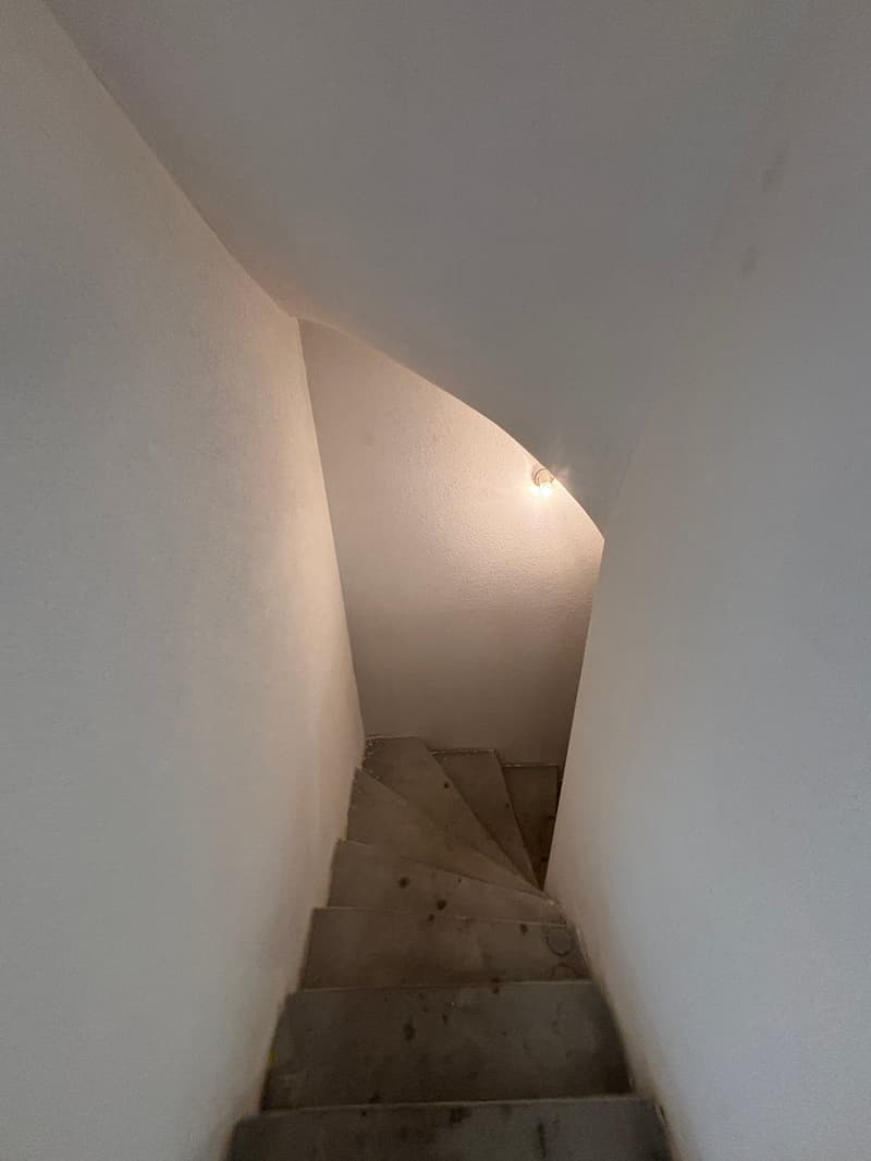 concrete steps, white walls, light on the ceiling