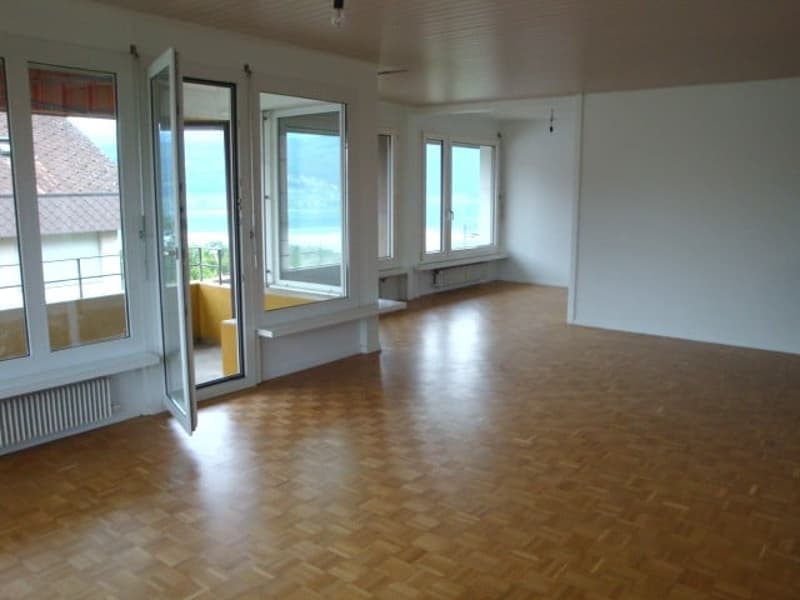 empty room, wooden floor, large windows, balcony, white walls, radiator