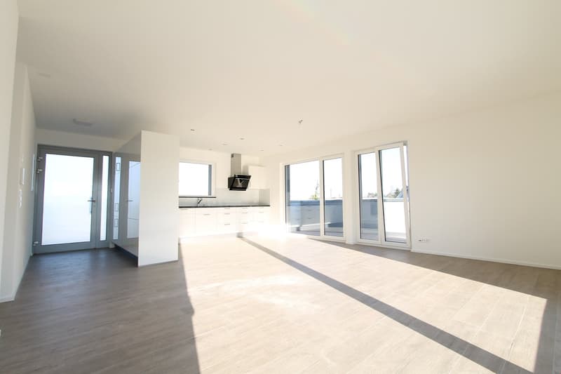 empty room, white walls, wooden floor, large windows, balcony, kitchen area