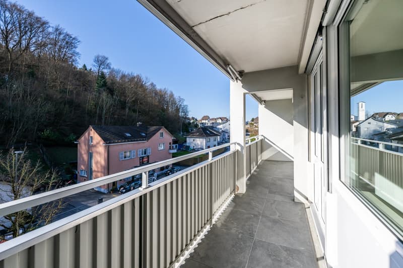 Balcony with railings, tiled floor, view of the street and houses