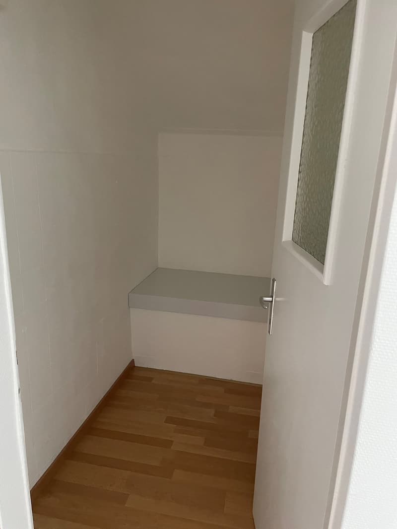 white walls, white bench, white door, wooden floor